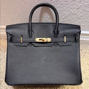 Elegant Black Leather Handbag with Gold Accents